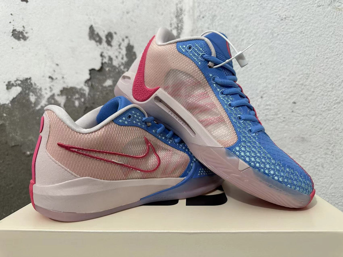 Pair of blue and pink Nike Kobe basketball shoes shown from the side