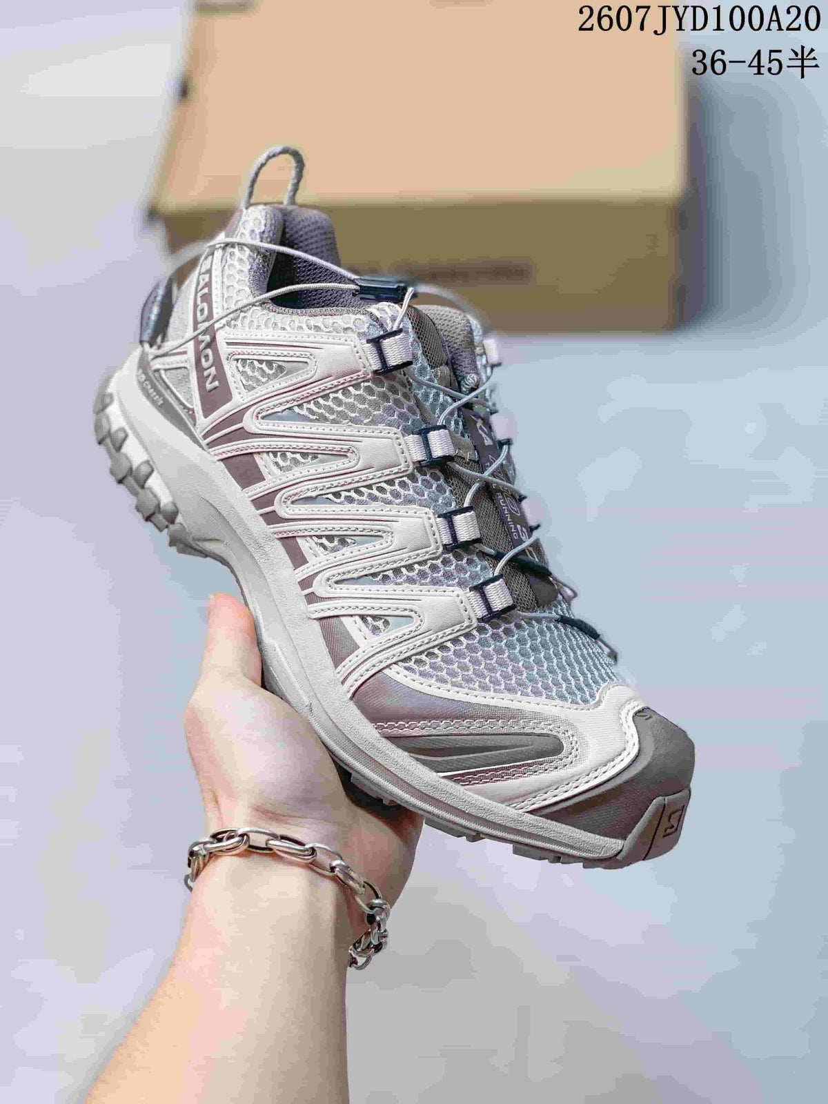 White, gray and muted purple Salomon XA PRO 3D trail shoe shown from a front-side angle.
