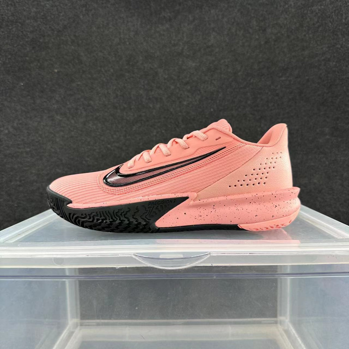 Side view of a pink Nike Precision 7 basketball shoe with a black Swoosh and outsole accents.