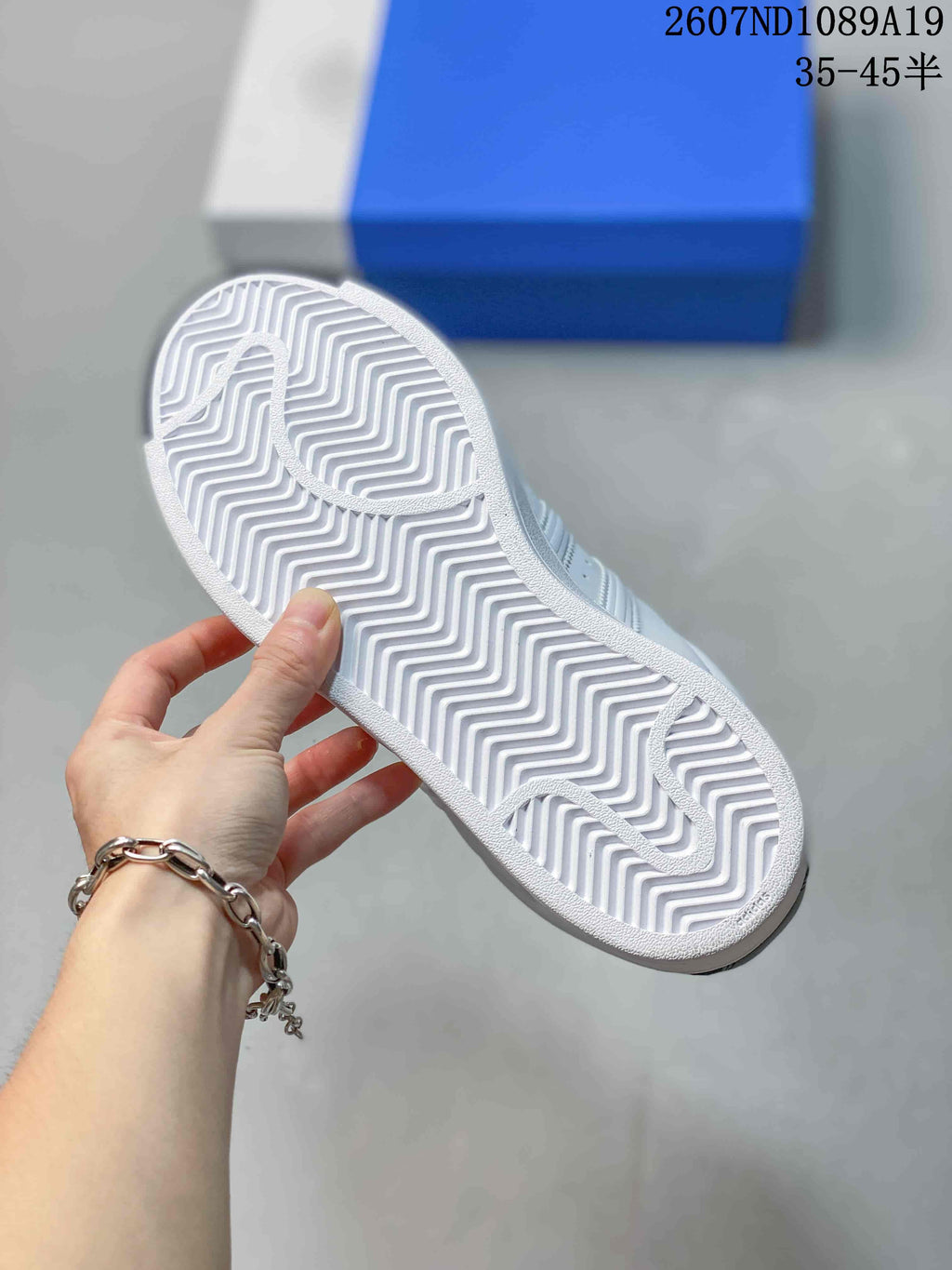 Underside of the sneaker showing a white rubber outsole with a zigzag tread pattern.