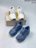 White and dark blue-gray On Cloudmonster 3 shoes shown together