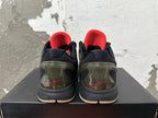 Rear view of black and camouflage Nike Kobe basketball shoes with red lining and signature heel details