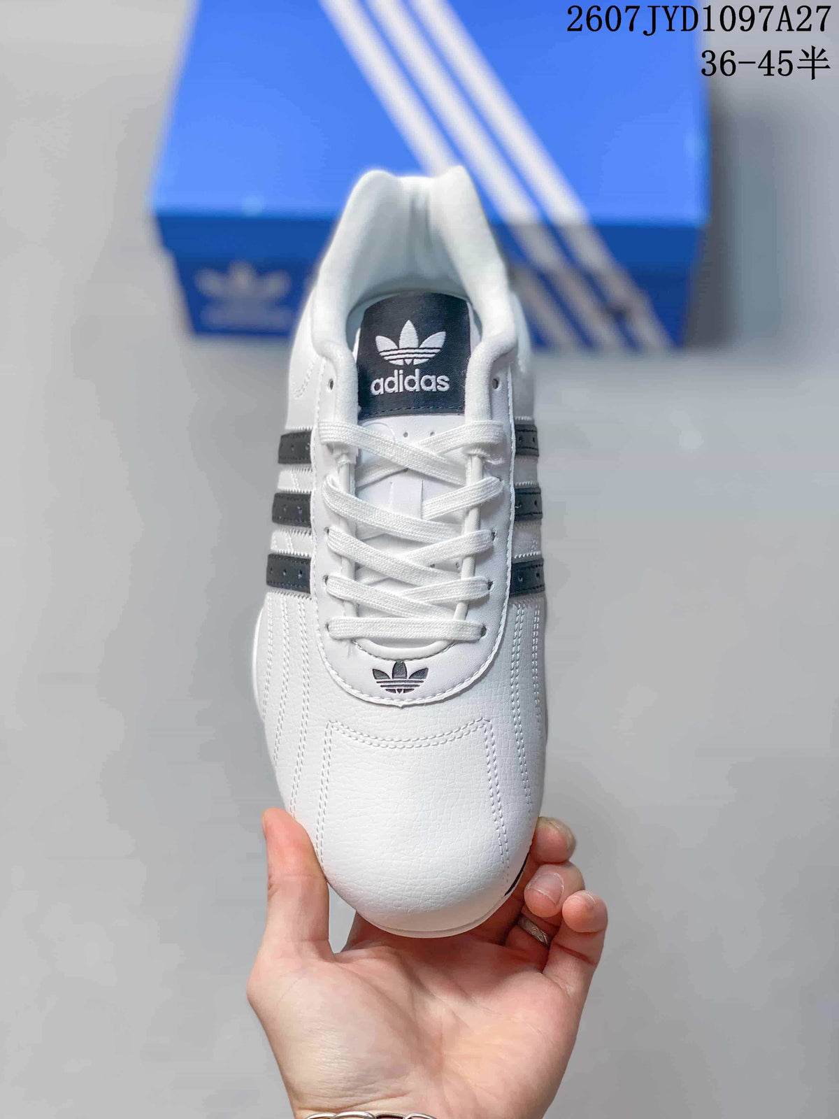Top view showing the white laces, dark tongue label, and Trefoil logo on the toe area.