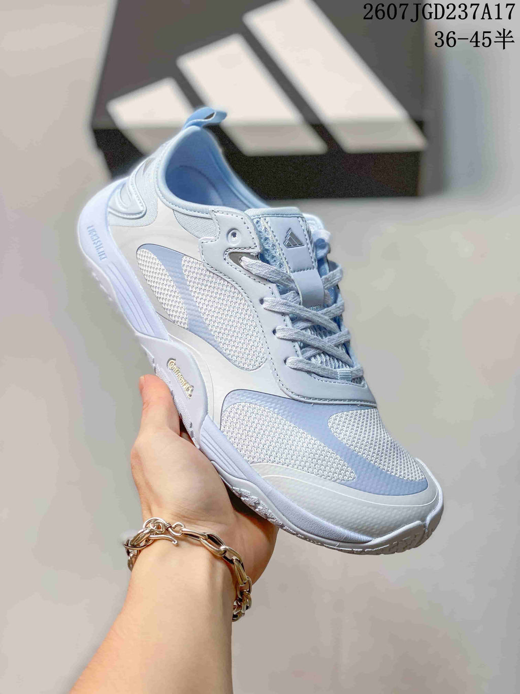 Angled side view of the crystal blue adidas sneaker showing the layered panels, laces and textured outsole.