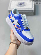 Angled side view showing the blue and white upper, star and shark graphics, and textured outsole.