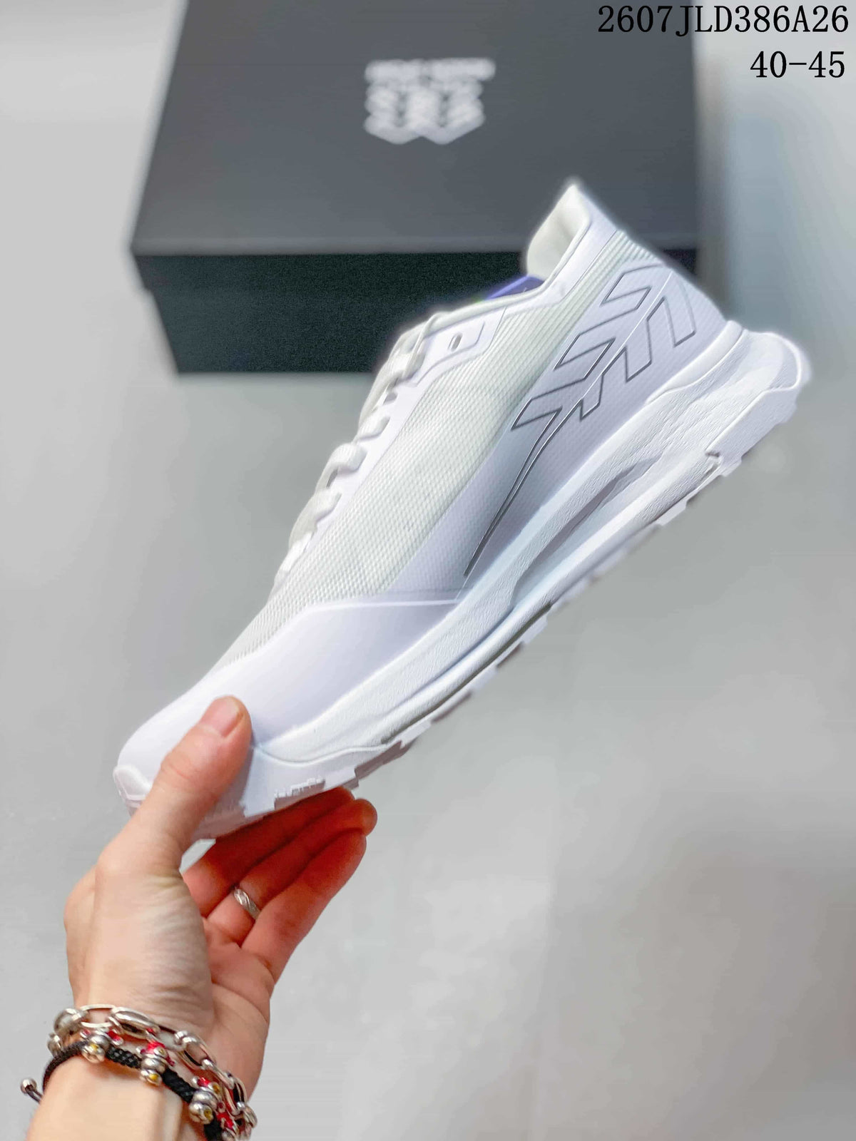 Side profile of the white sneaker showing the mesh upper, layered side design and thick white sole.
