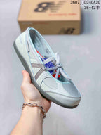Angled side view highlighting the layered design, lace-up closure, padded collar, and gray outsole.