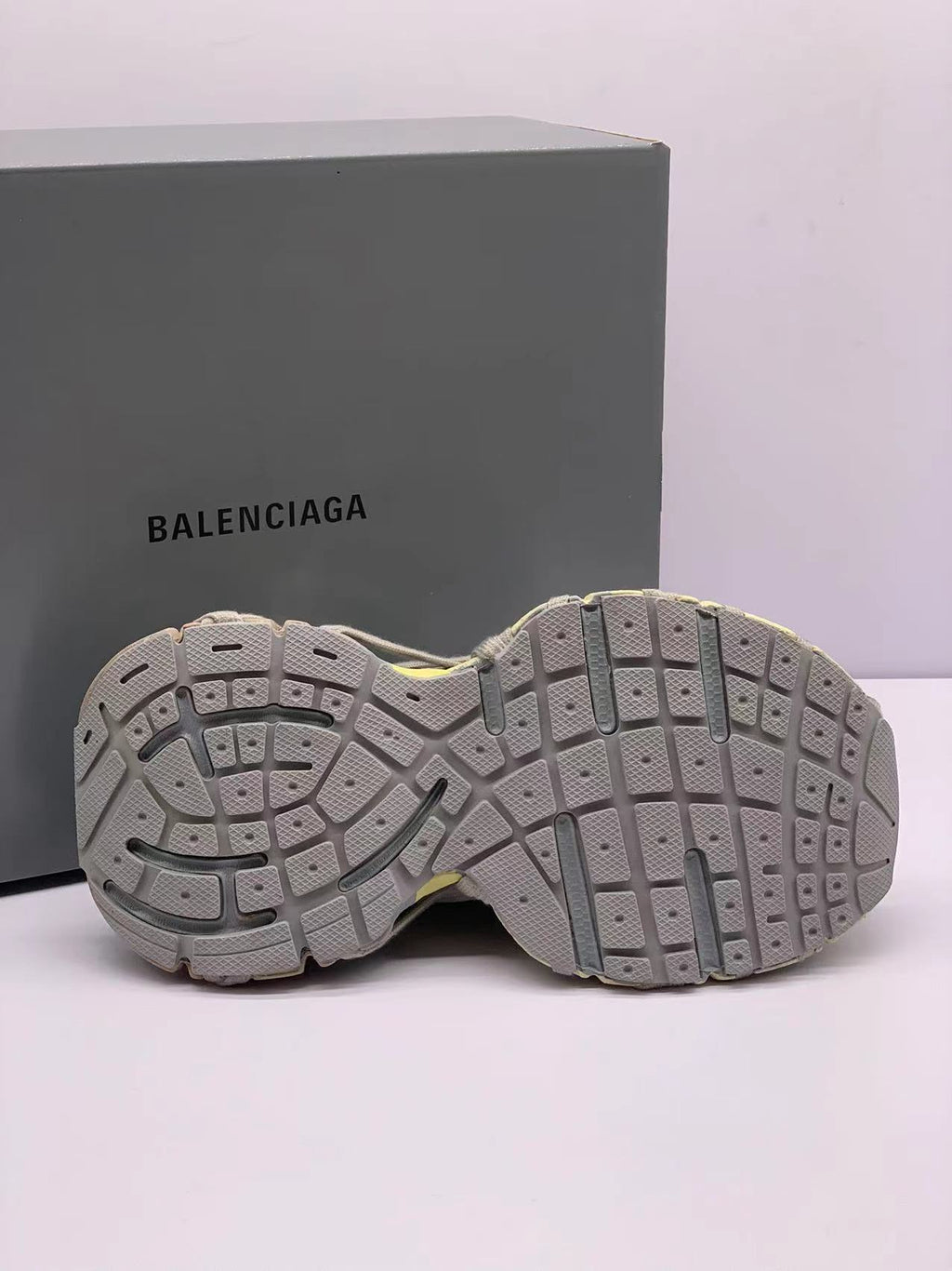 Underside view displaying the segmented rubber outsole and textured tread pattern.