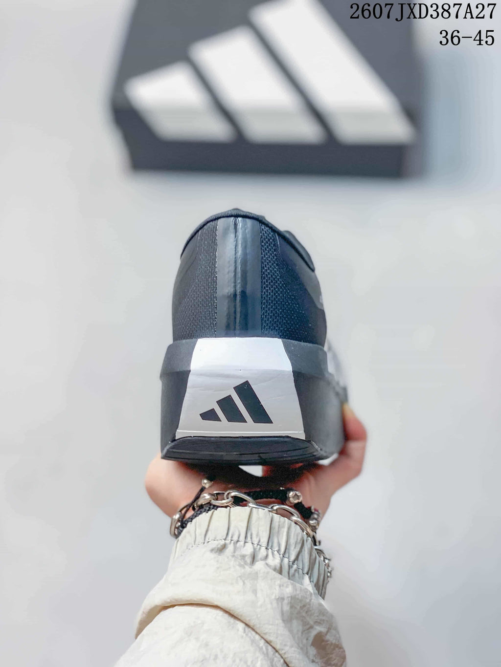 Rear view of the sneaker showing the black heel, white heel panel and adidas logo.