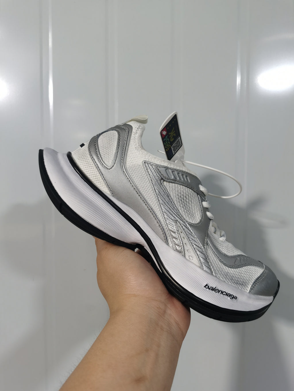 Angled view of the white and silver Balenciaga Circuit sneaker with visible Balenciaga branding on the midsole and tonal upper details.