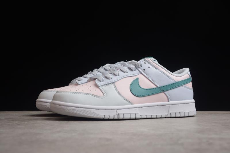 Angled side view showing layered white and pale pink panels with a green Swoosh.