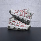 Pair of white Nike Air More Uptempo sneakers with cherry graphics and pink-trimmed lettering
