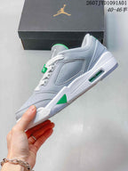 Side profile of the grey low-top sneaker with green accents and visible midsole window