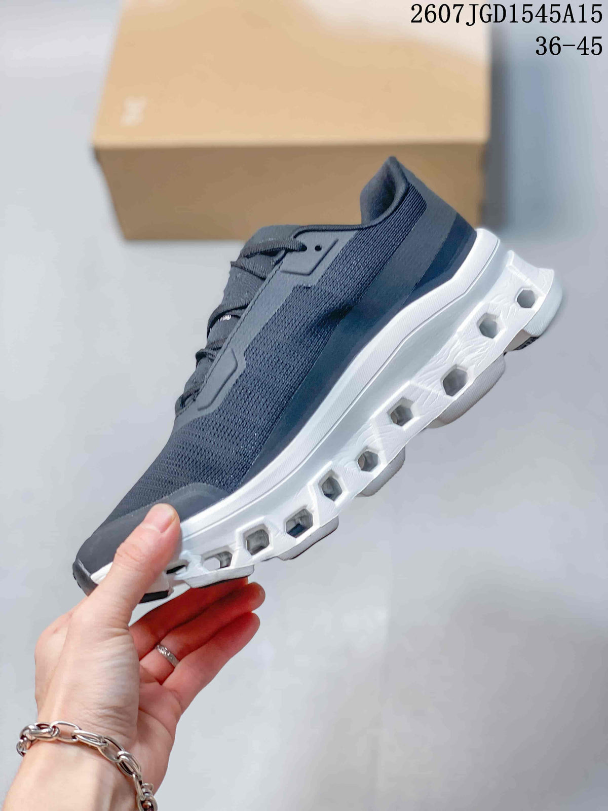 Side view highlighting the woven-texture upper, layered panels, and open geometric sections in the white outsole.