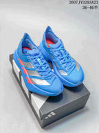Pair of blue Adidas Ultrabounce sneakers with silver panels and red accents displayed on a shoebox; image text shows style code 2607JYD293A23 and sizes 36–46.