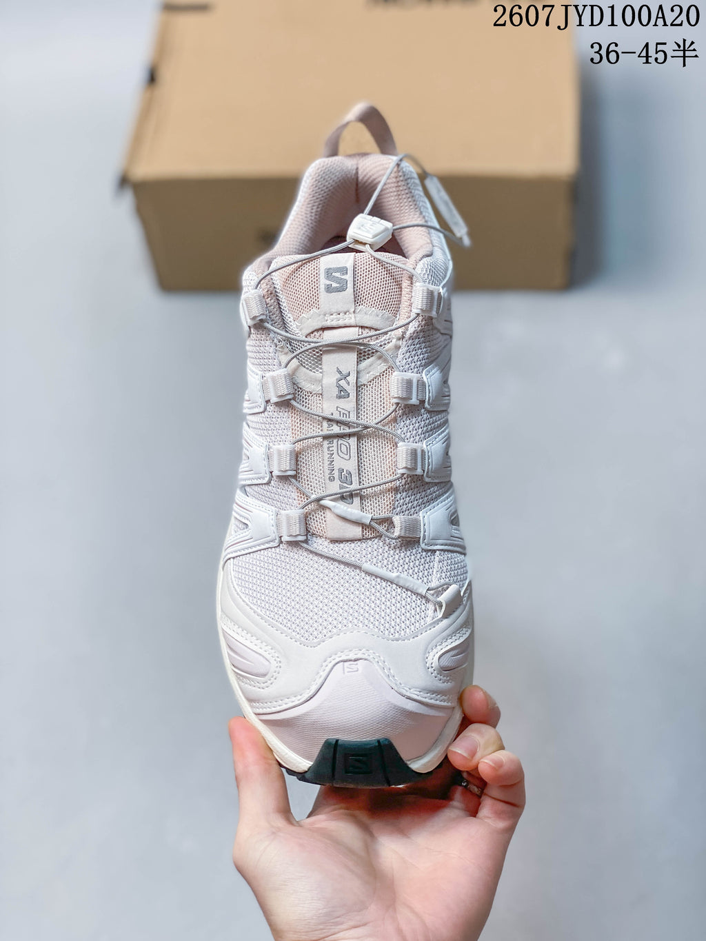 Top view of the white Salomon XA PRO 3D sneaker showing the tongue branding and cord-based quick-lace system.