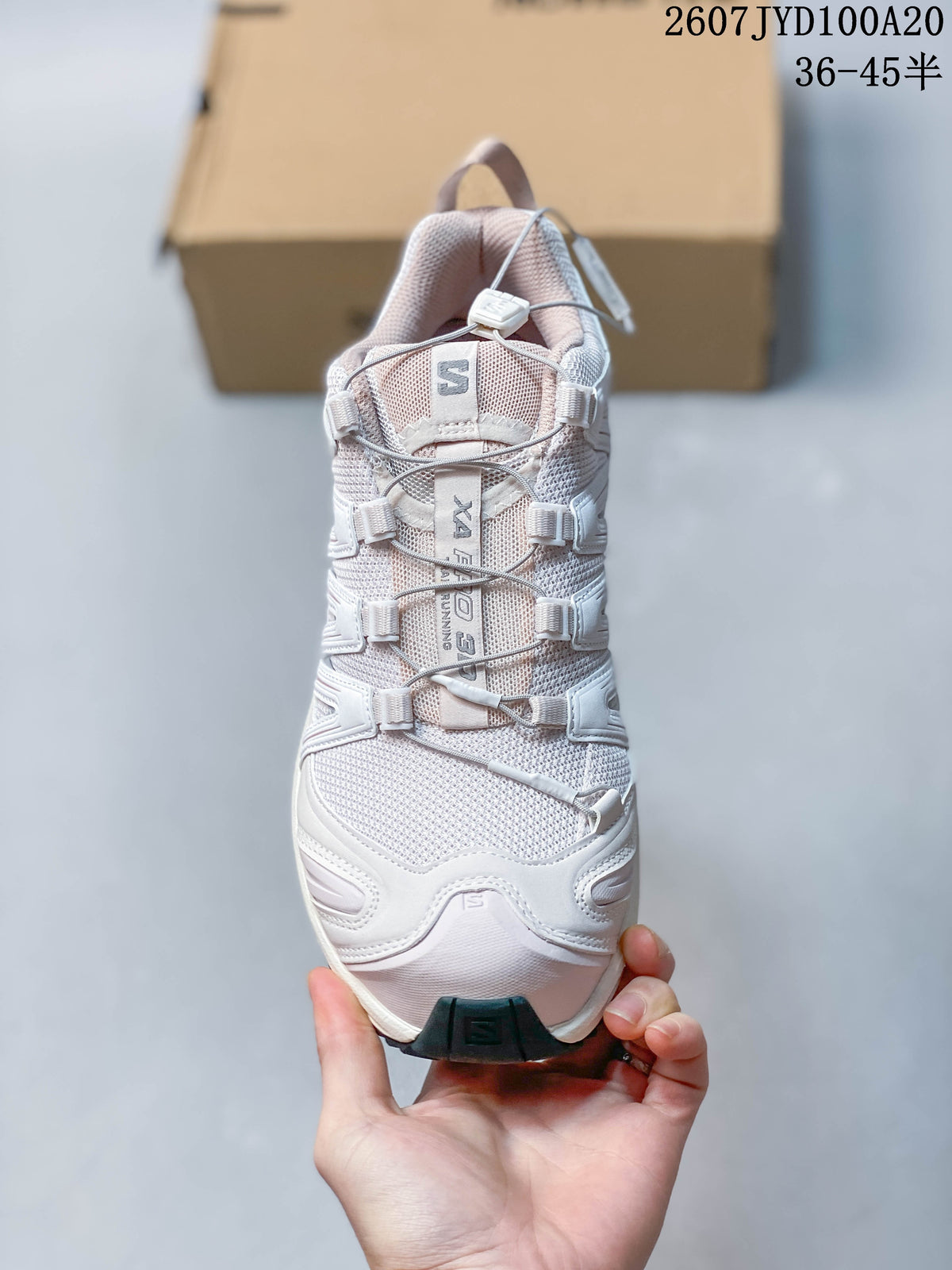 Top view of the white Salomon XA PRO 3D sneaker showing the tongue branding and cord-based quick-lace system.