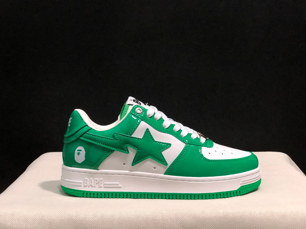 Outer side profile showing the green and white color blocking, star graphic, heel emblem, and BAPE branding on the midsole.