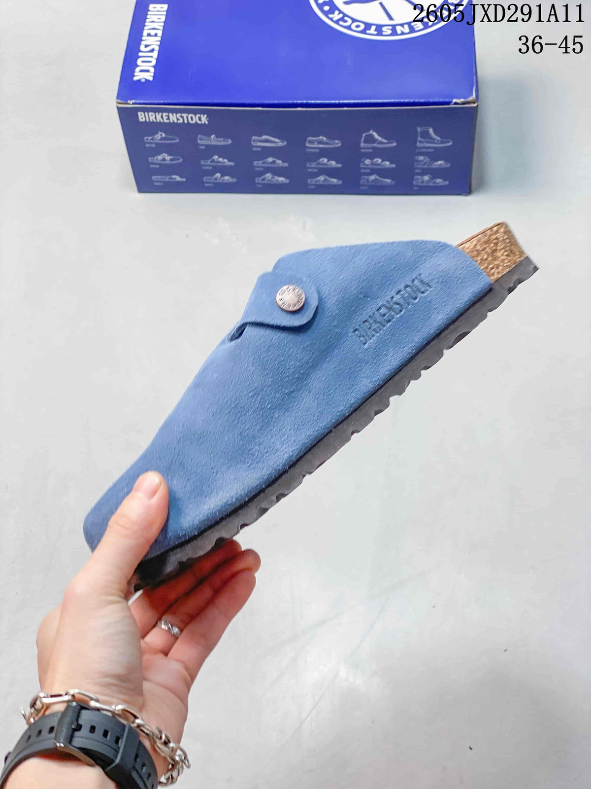 Side view of the blue closed-toe clog sandal with a buckle strap and contoured sole profile.