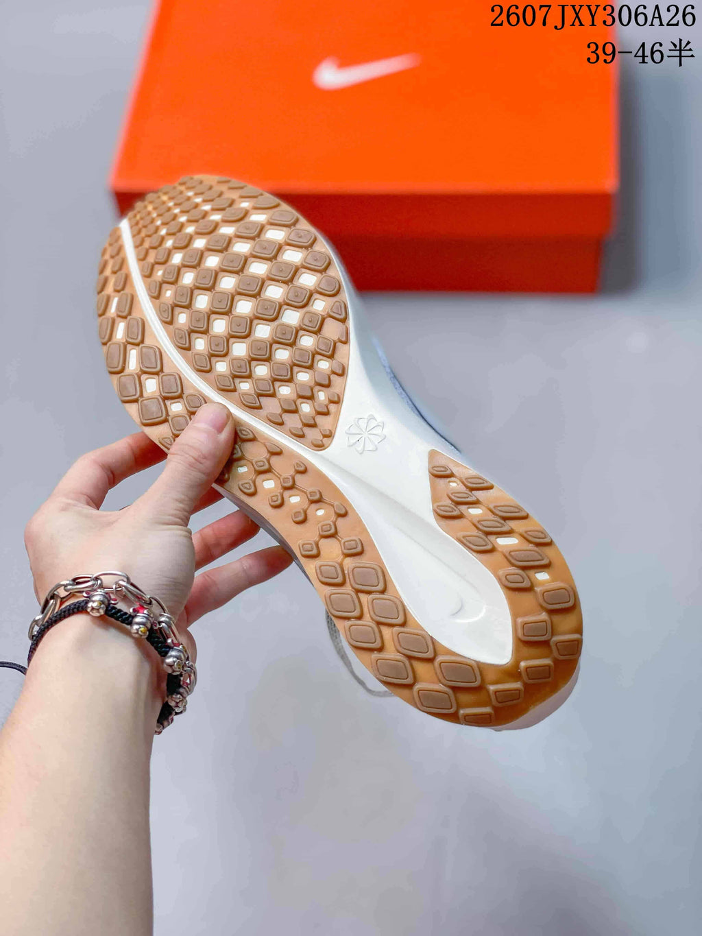 Close-up of the gum-colored textured outsole and white midsole of the sneaker.