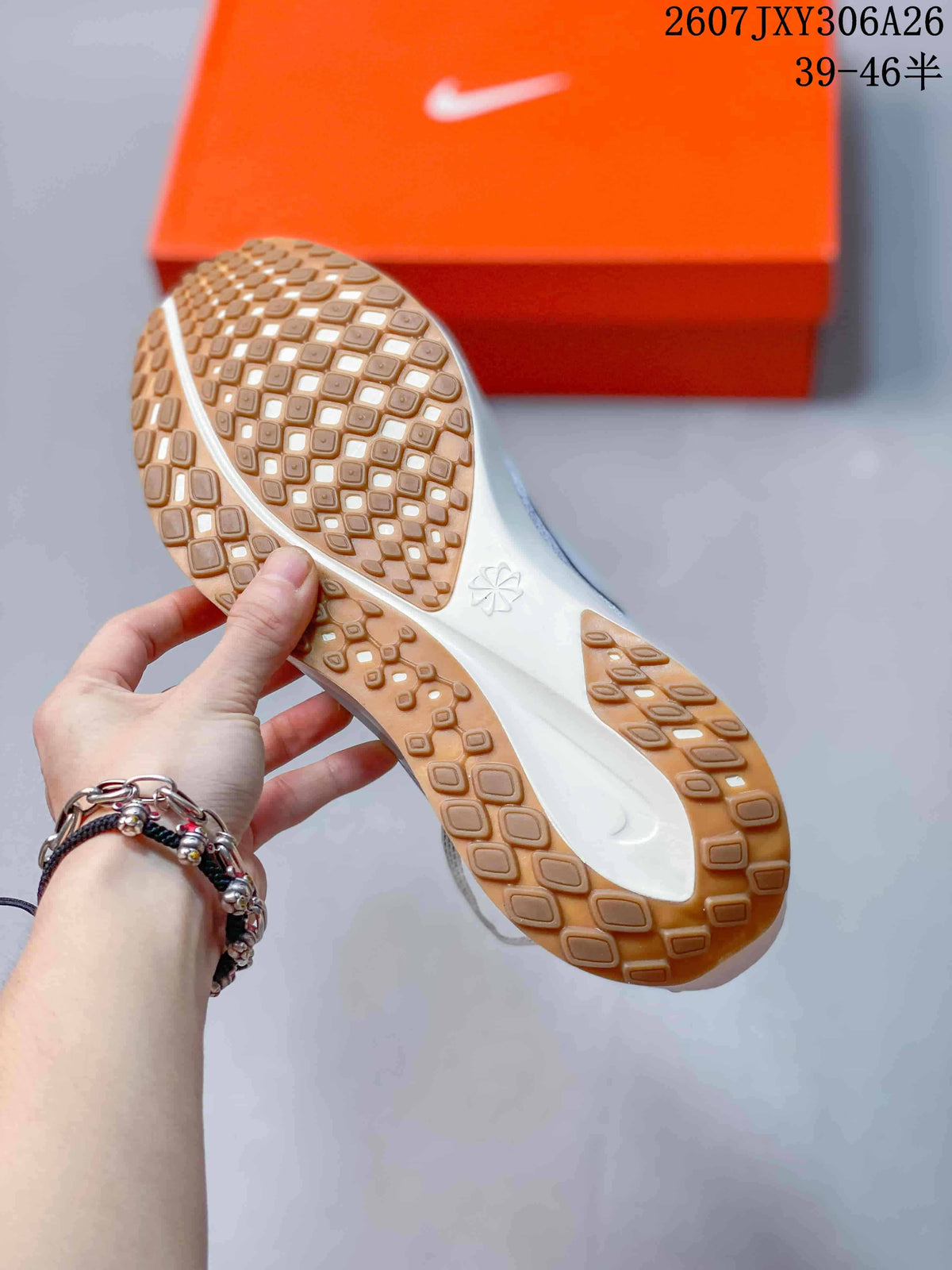 Close-up of the gum-colored textured outsole and white midsole of the sneaker.