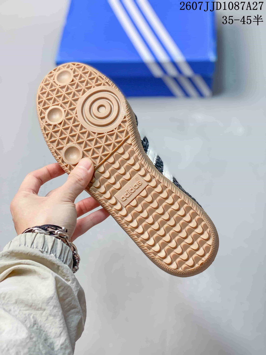Close-up of the gum-colored outsole showing its textured tread pattern and adidas branding.