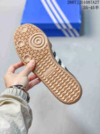 Close-up of the gum-colored outsole showing its textured tread pattern and adidas branding.