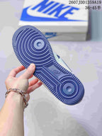 Bottom view of a sneaker showing a blue rubber outsole with concentric circular traction patterns and molded branding.