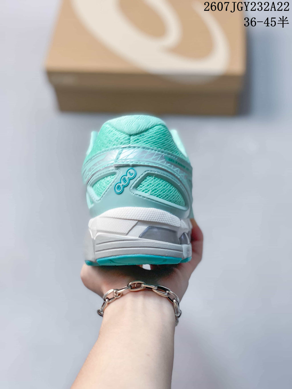 Rear view showing the padded heel collar, ASICS branding, and layered heel construction.