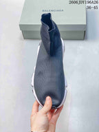 Top view of a dark gray sock-style sneaker showing the seamless-looking knit upper and high ankle collar.