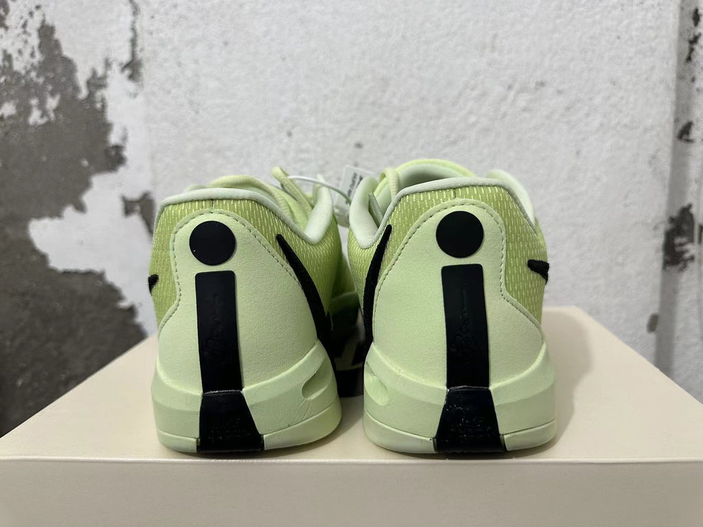 Rear view of pale yellow-green Nike basketball shoes with black heel details