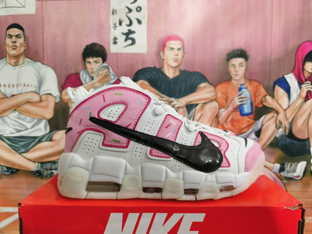 Side view showing oversized lettering, black Swoosh, pink panels, and chunky sole.