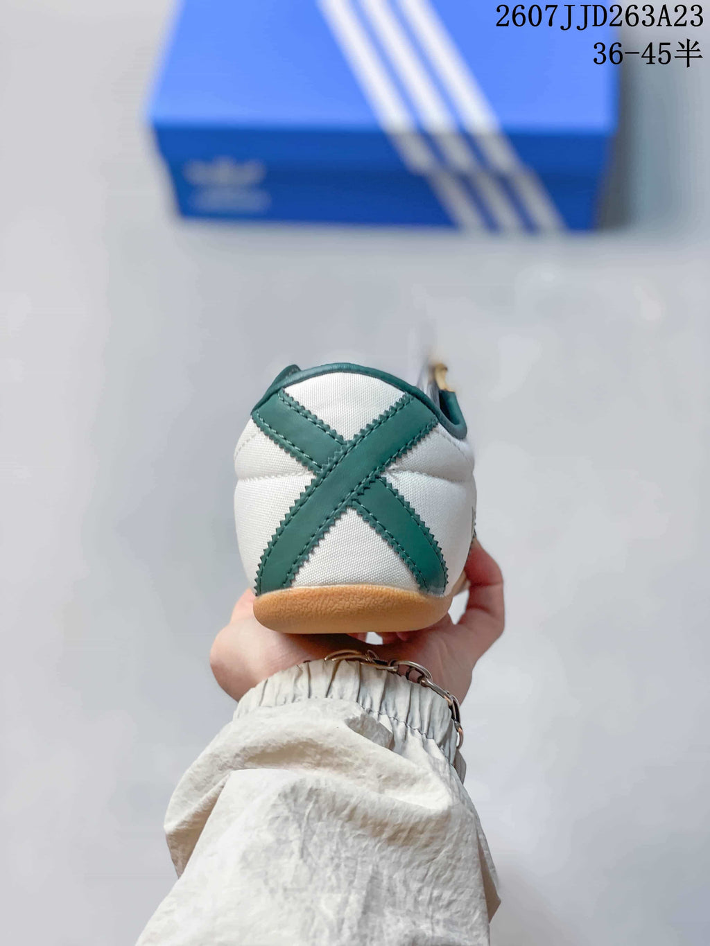 Rear view of the sneaker showing the green crossed heel detail and gum outsole.