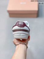 Rear view of the sneaker showing burgundy heel accents, white padded collar, and Miu Miu branding on the heel tab.