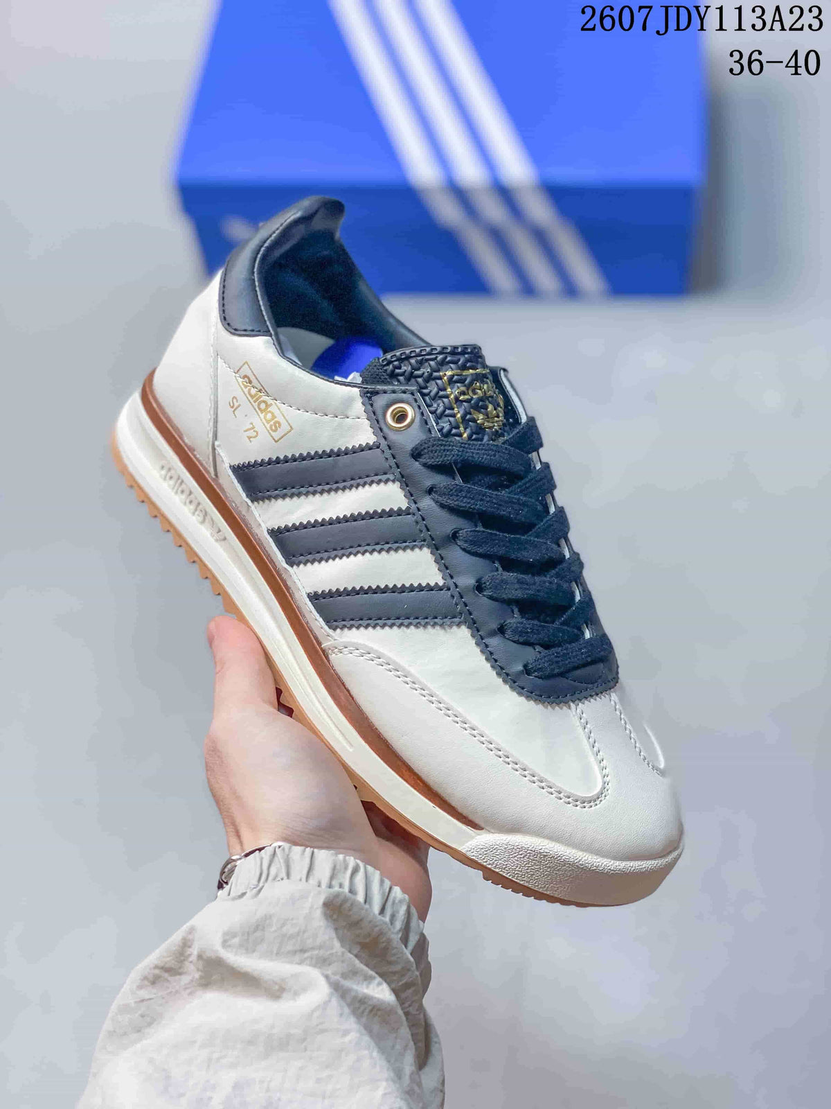 White adidas SL 72 sneaker with navy overlays and laces, dark side stripes and a gum-look outsole.
