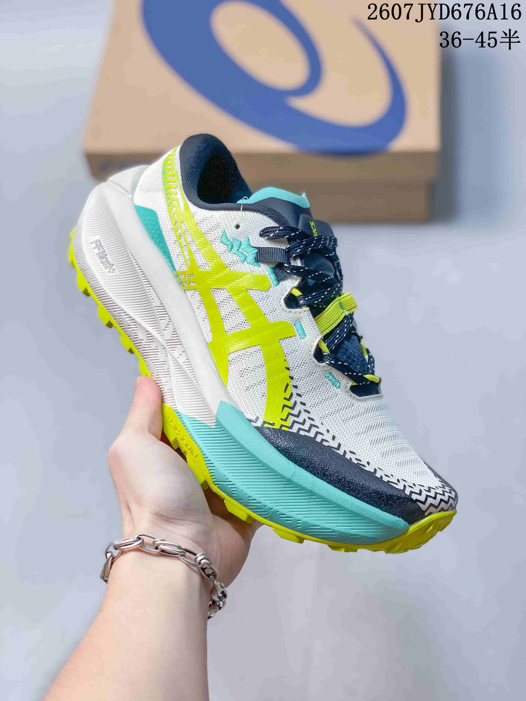 Angled side view highlighting the white upper, lime ASICS branding, turquoise midsole accent, dark toe guard, and lime outsole.