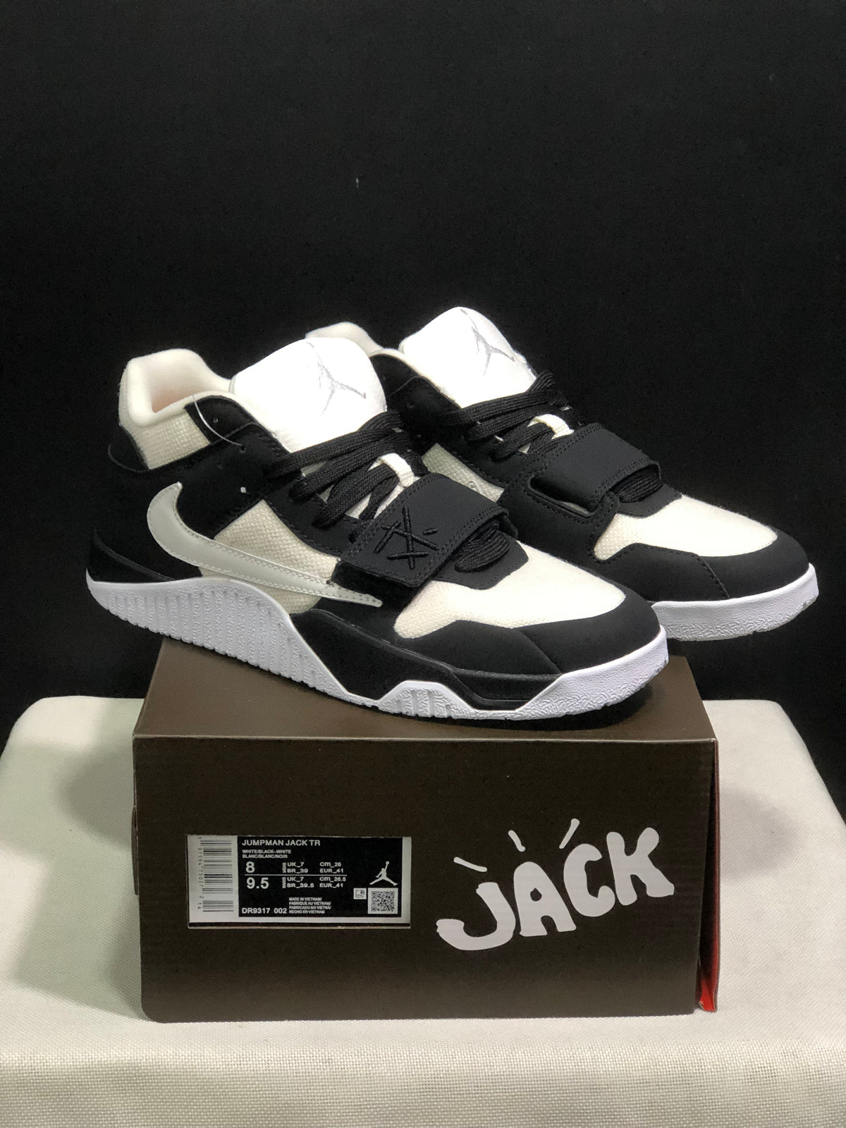 Pair of black and white Jordan Jumpman Jack sneakers displayed on a labeled box.