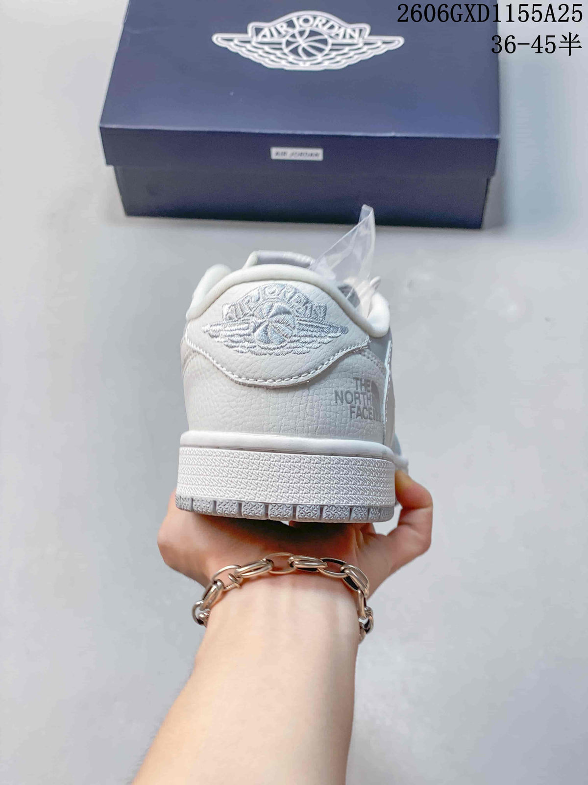 Rear view of the sneaker showing heel graphics and light grey details.