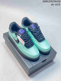 Pair of mint-green and navy Nike Air Force 1 '07 Low sneakers on a shoe box