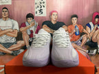 Front view of white and pale purple Nike basketball shoes with laces