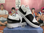 Pair of white and black basketball shoes shown from the side