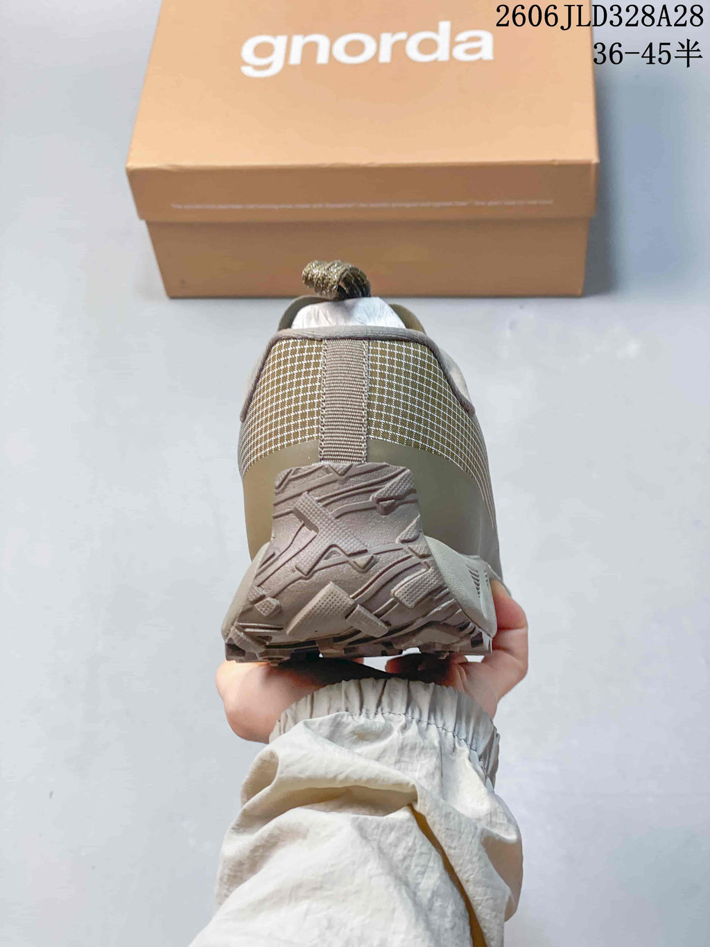 Rear view of an olive hiking shoe showing the heel and outsole tread.