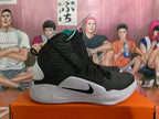 Side view showing the black textured upper, Nike Swoosh and speckled white sole