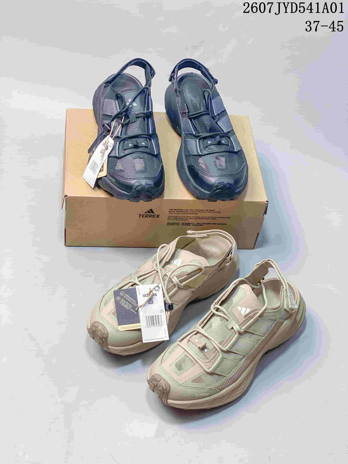 Dark navy and pale green adidas Terrex outdoor shoes shown together