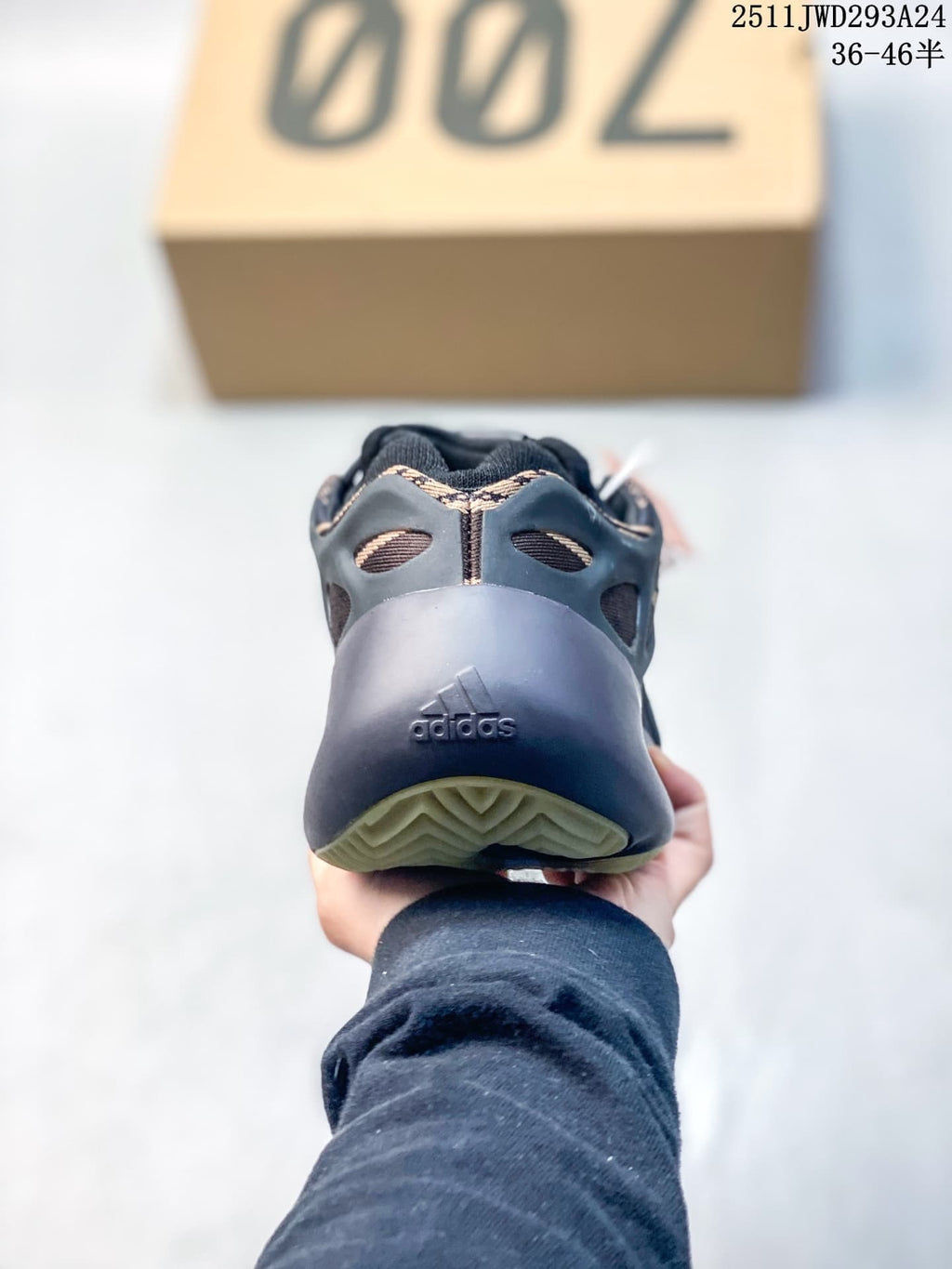 Rear view of a black sneaker showing the sculpted heel, Adidas branding, and textured outsole.