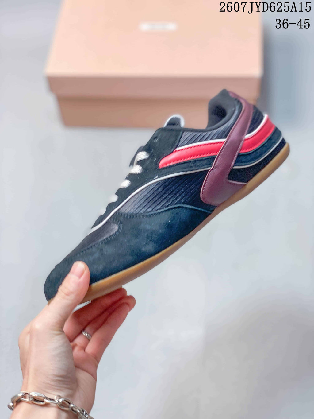 Side view showing the black upper, red side stripe, burgundy overlay and low-profile gum sole.