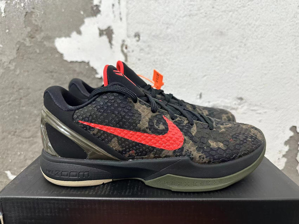 Side view showing the red Swoosh, camouflage upper, and sculpted heel of a Nike Kobe basketball shoe