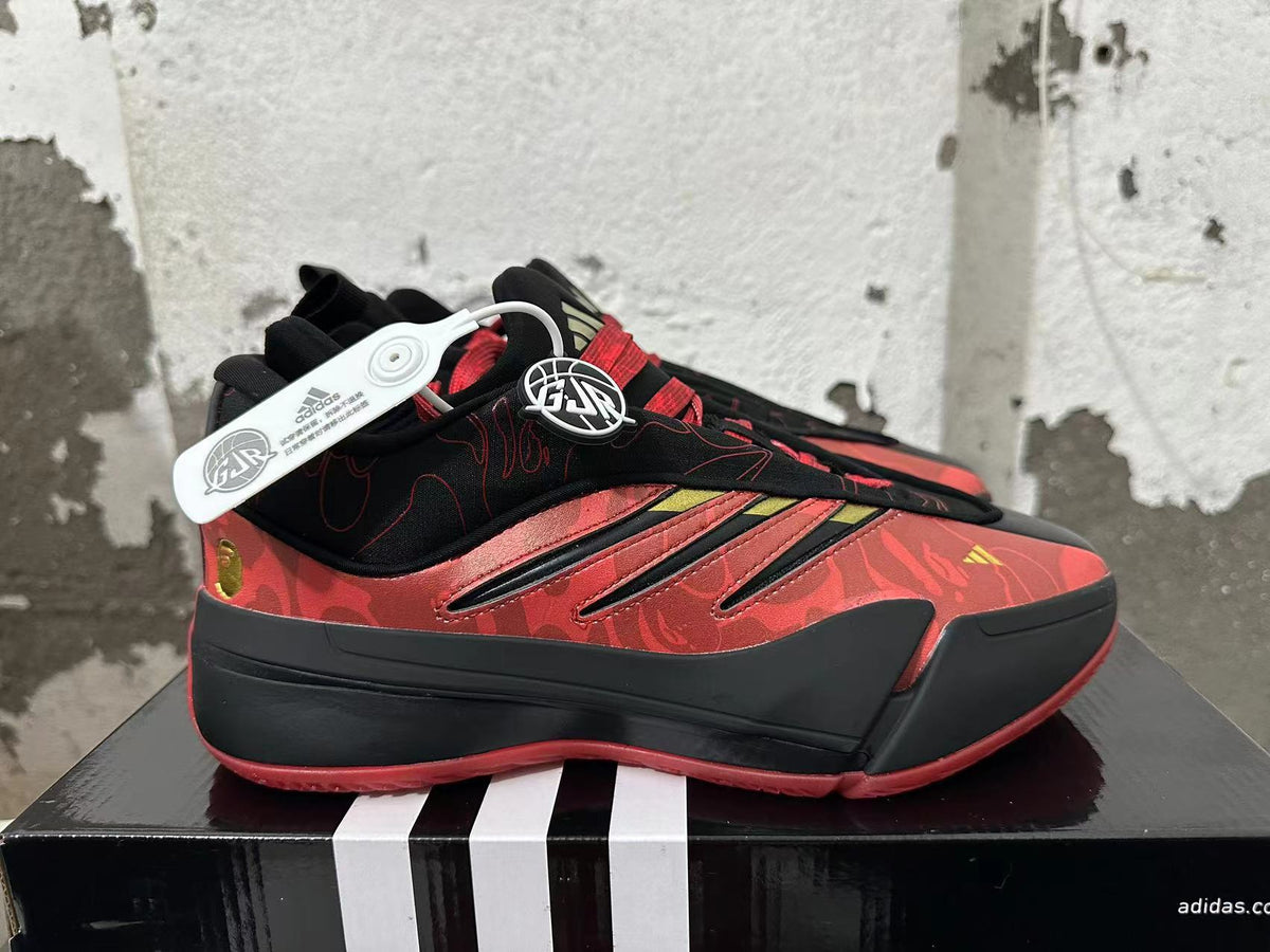 Side view of red and black basketball shoe with floral pattern and three-stripe detailing