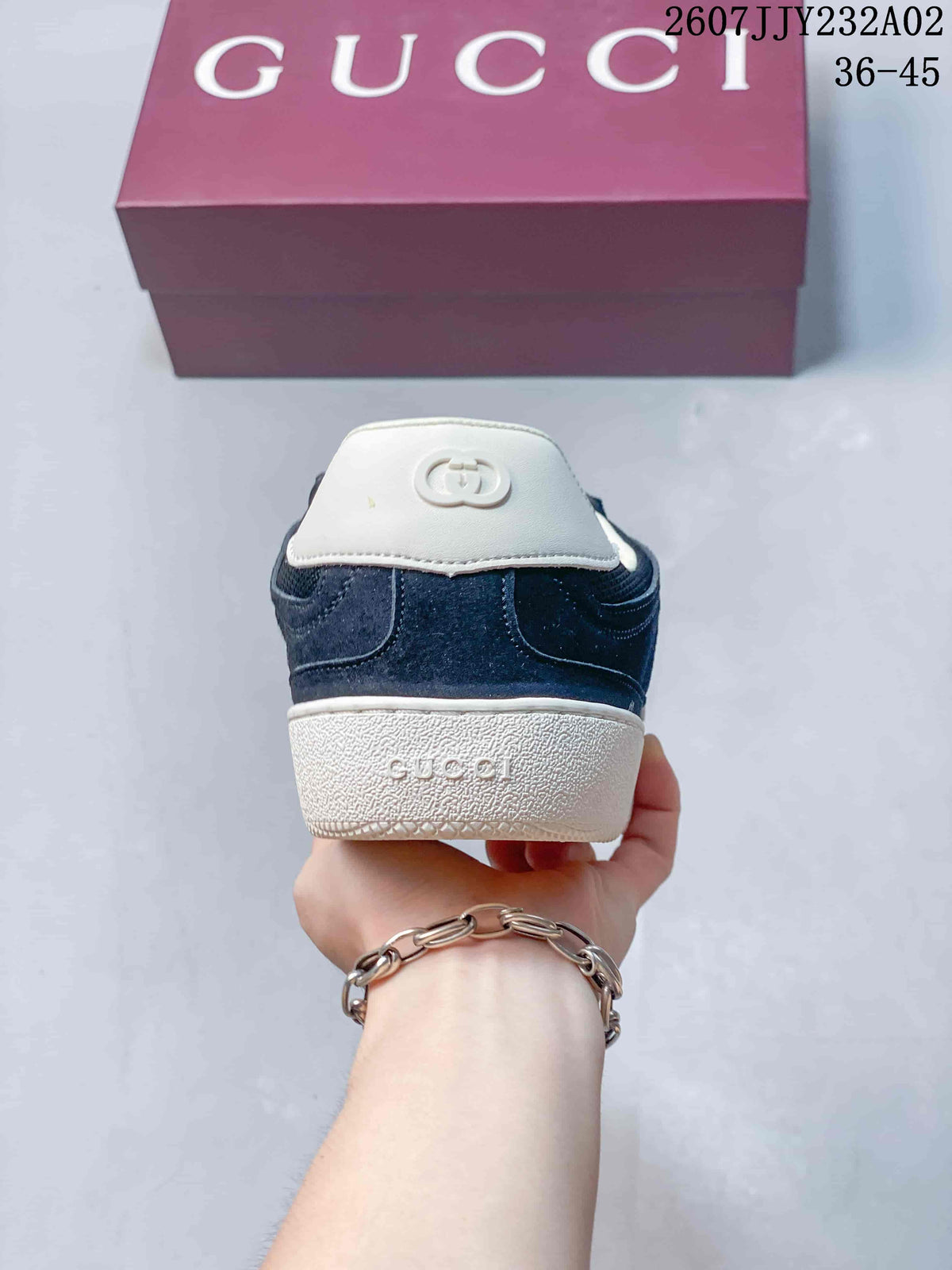 Rear view of the sneakers showing the heel and white sole