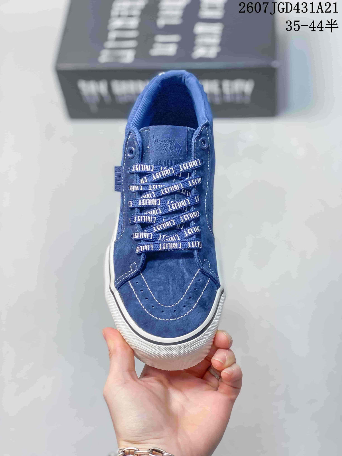 Top view of the blue sneaker showing the patterned laces, stitched toe panel, and tonal upper.